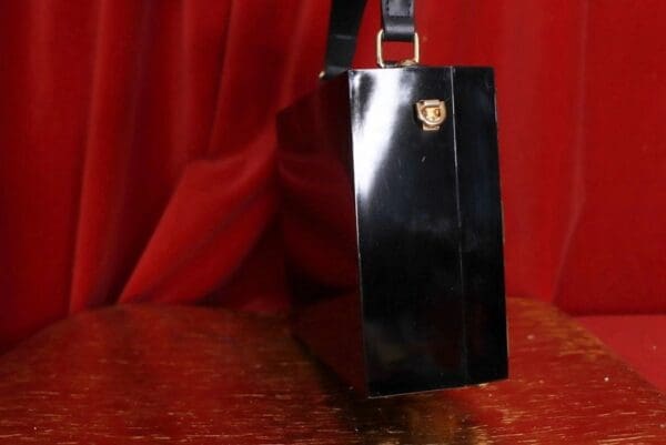 A black purse sitting on top of a table.