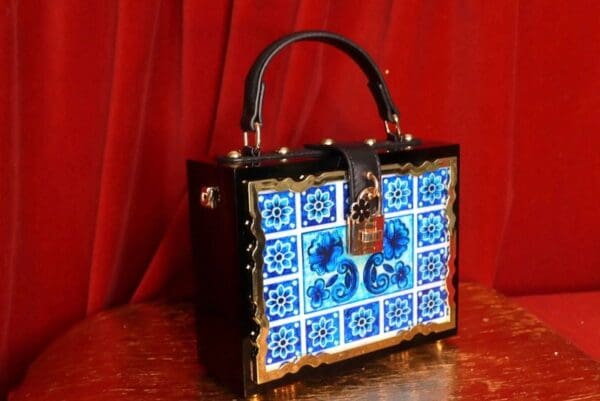 A blue and white tile bag sitting on top of a table.