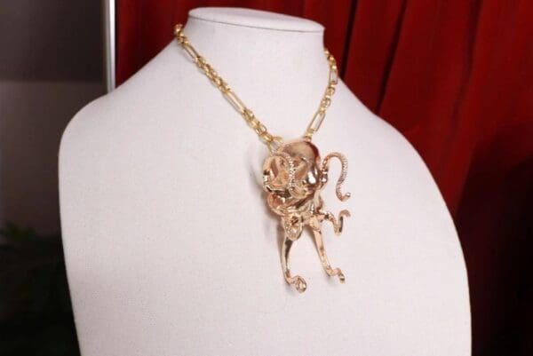 A gold chain with a monkey on it