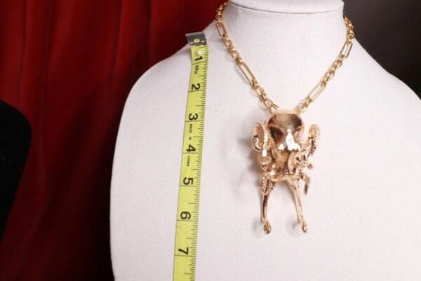 A skeleton necklace is shown on display.