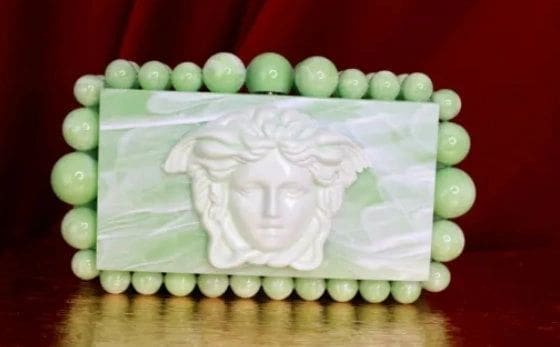 A close up of the face on a green bracelet