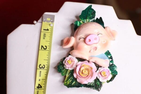 A pig with flowers on it's head and feet.