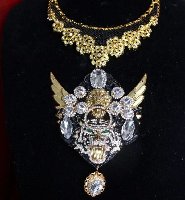 A black shirt with gold and silver jewelry on it.