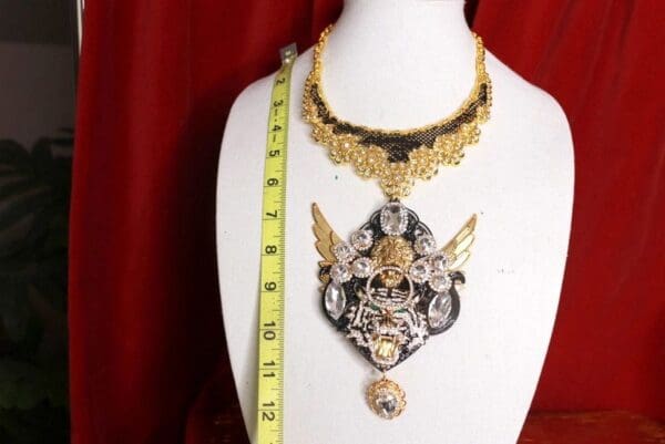 A necklace is shown on the bust of a mannequin.