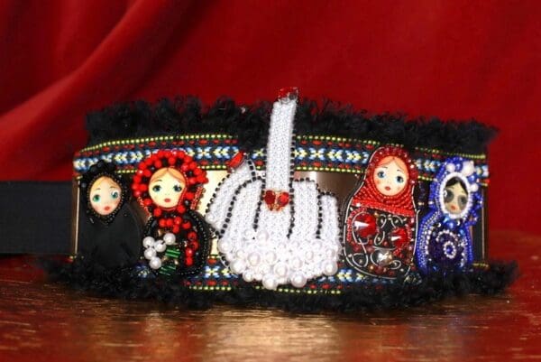 A close up of a belt with dolls on it