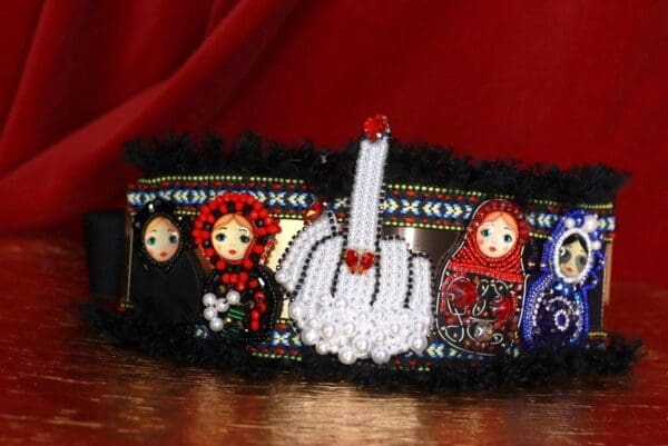 A close up of a headband with dolls