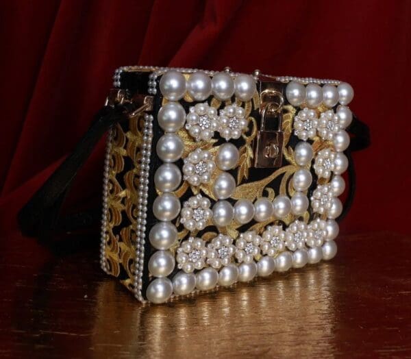 A purse made of pearls and gold leaves
