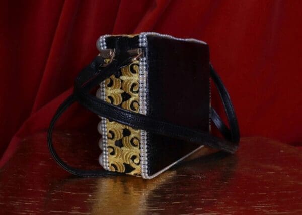 A black and white purse sitting on top of a table.