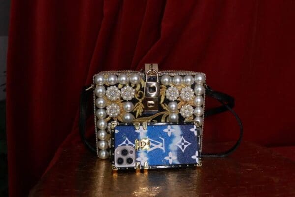 A purse and wallet sitting on top of a table.