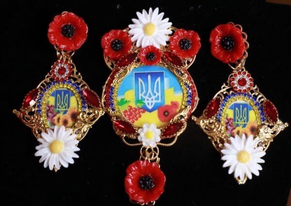 A woman 's hair ornament with flowers and a ukrainian emblem.