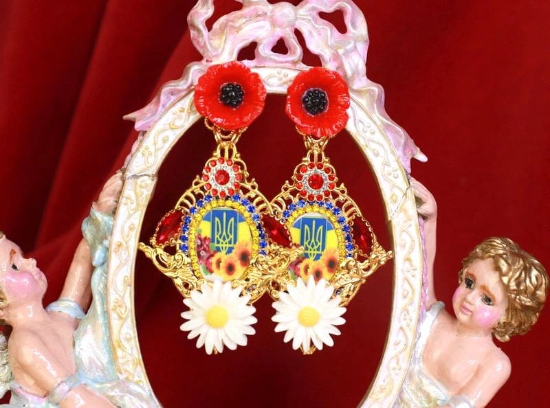 A pair of earrings with flowers and a bird.