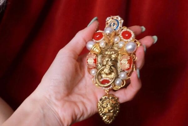 A person holding onto some jewelry in their hand