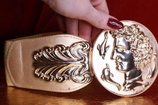 A woman is holding onto the bottom of her sandals
