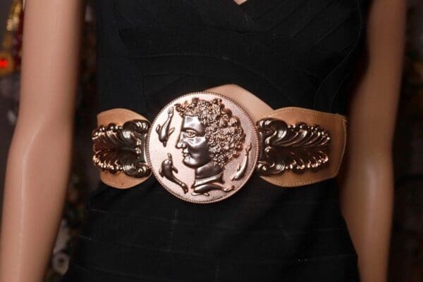 A woman wearing a black dress and a belt