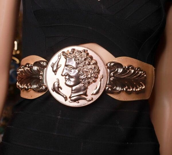 A woman wearing a black dress and a belt