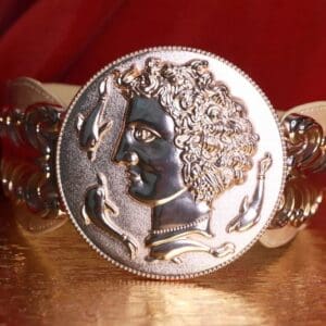 A close up of the coin on the bracelet