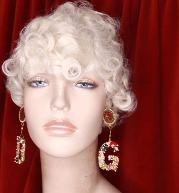 A mannequin with white curly hair and two earrings.