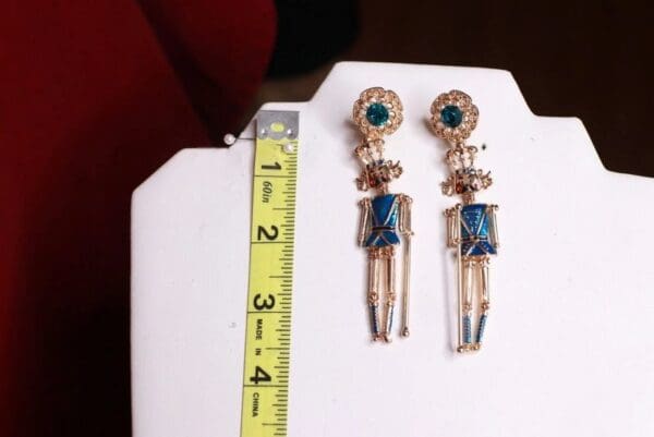 A pair of earrings sitting on top of a white board.