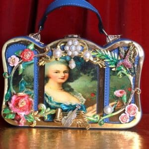 A purse with a picture of a woman on it.