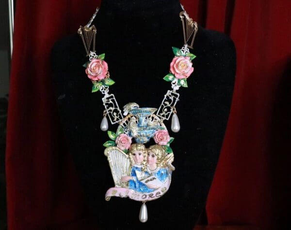 A necklace with pink roses and a picture of two people.