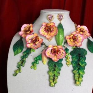 A white mannequin with pink flowers and green leaves.