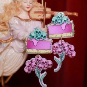 A pink cake with flowers on top of it.