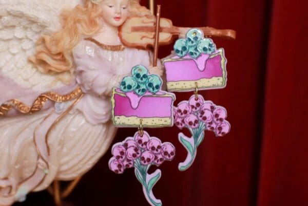 A pink cake with flowers on top of it.