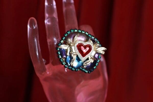 A hand with a heart on it and some beads