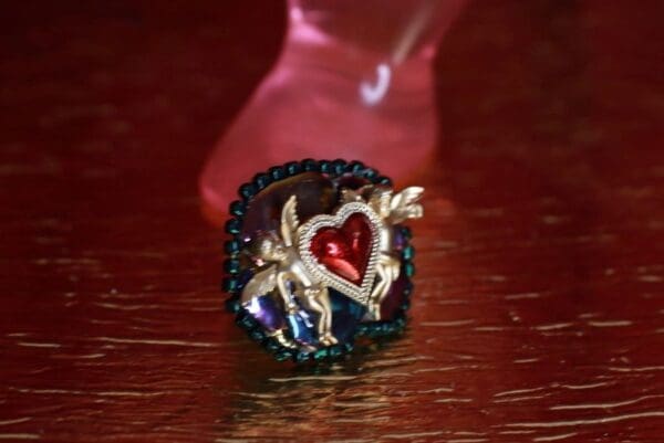 A red glass bottle with a heart on it.