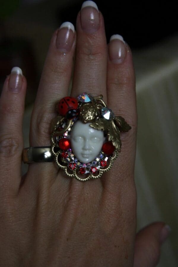 A woman 's hand with a ring on it