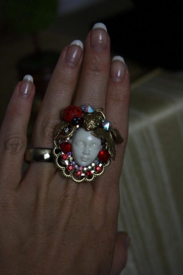 A woman 's hand with a ring on it