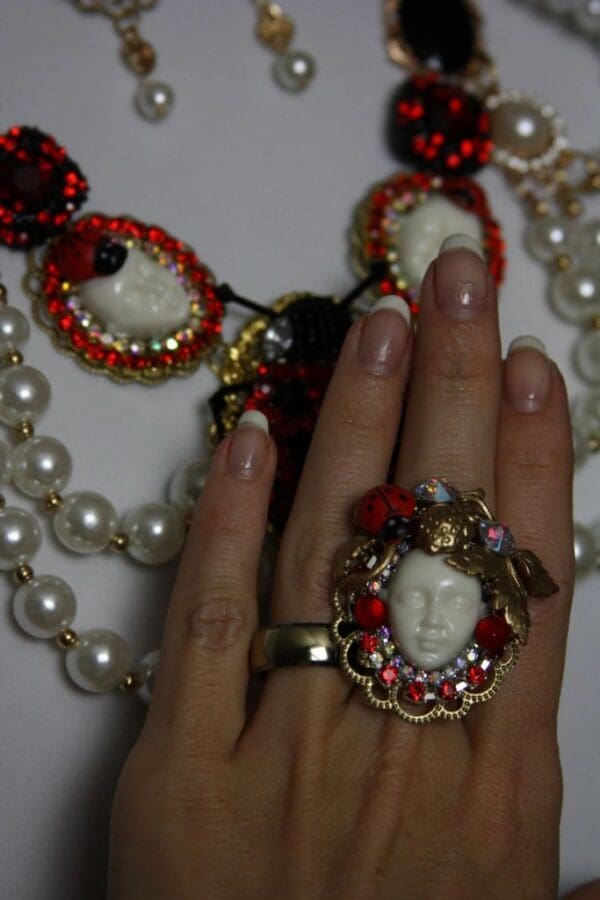 A woman 's hand with a ring on her finger.
