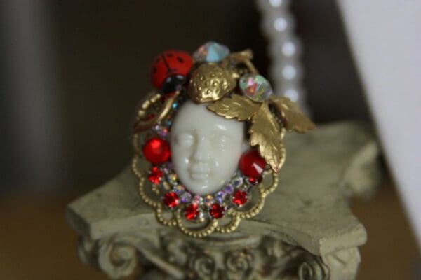 A white face with red and blue beads around it.