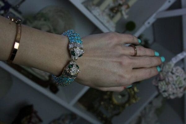 A woman 's hands with rings on top of them.
