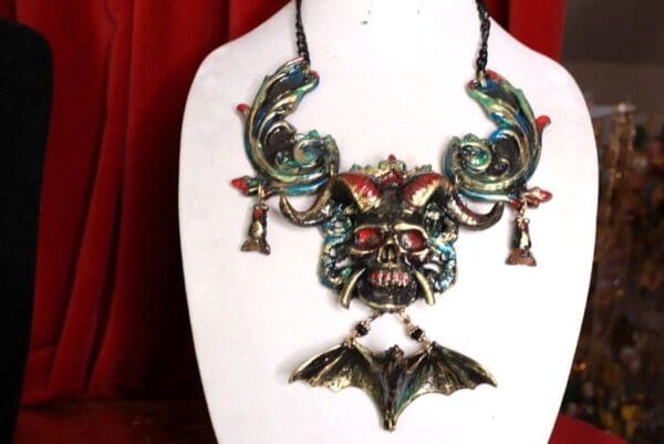 A necklace with a bat and skull on it