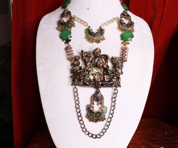 A necklace with green beads and chains on it