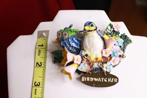 A bird figurine sitting on top of a table.