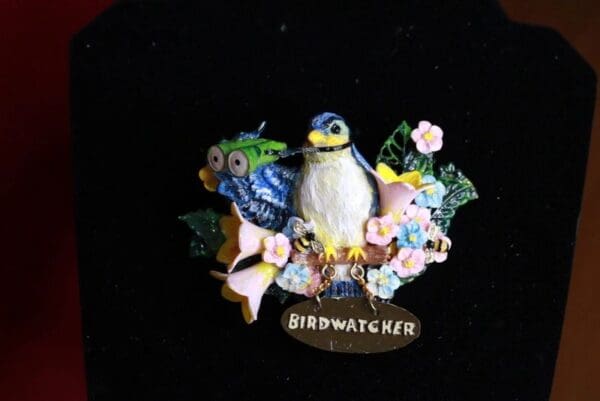 A bird with flowers and other decorations on it.