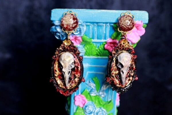 A pair of earrings with skulls on them.