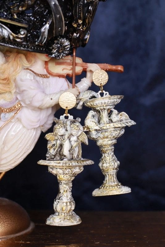 A couple of silver statues are sitting on top of each other