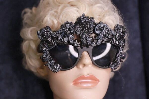A mannequin wearing sunglasses with curly blond hair.