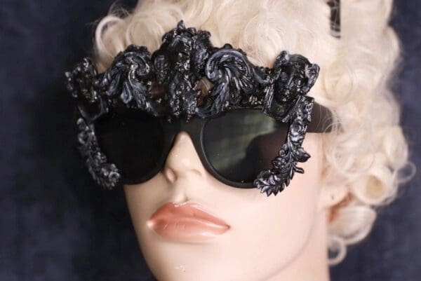 A mannequin wearing sunglasses with black flowers on them.