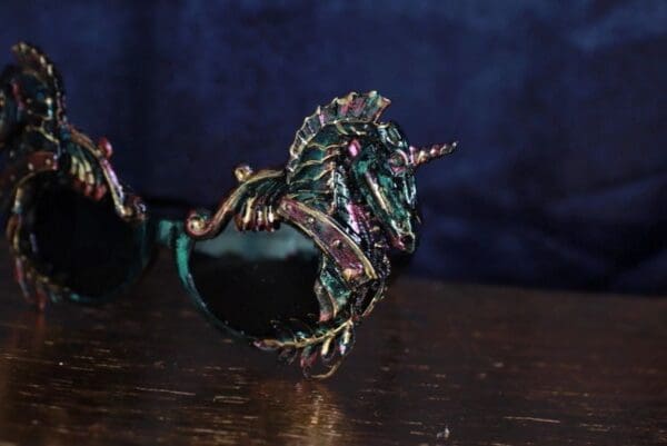 A green bird with a unicorn horn on its head.