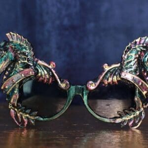 A pair of green and pink glasses sitting on top of a wooden table.