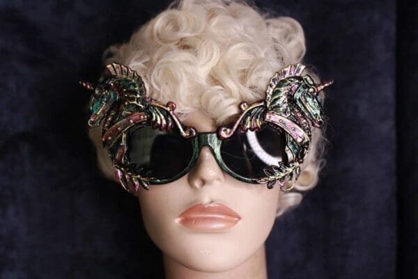 A mannequin wearing sunglasses with green and pink leaves.