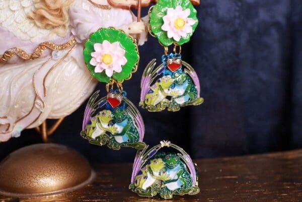 A close up of three earrings on a table