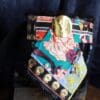 A colorful scarf with gold accents on top of it.