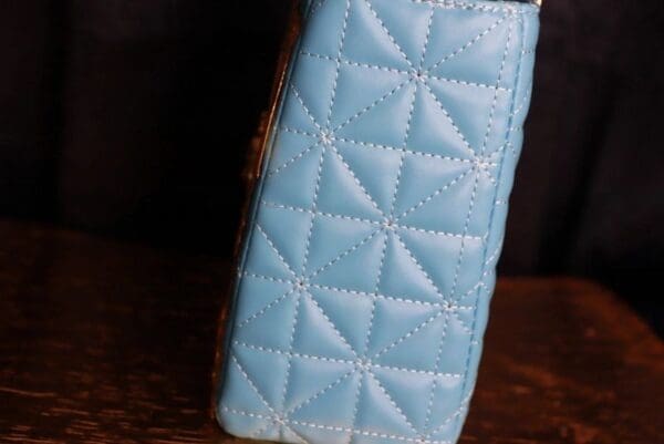 A close up of the blue leather on a purse