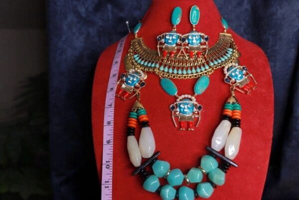 A red display with a necklace and earrings on it
