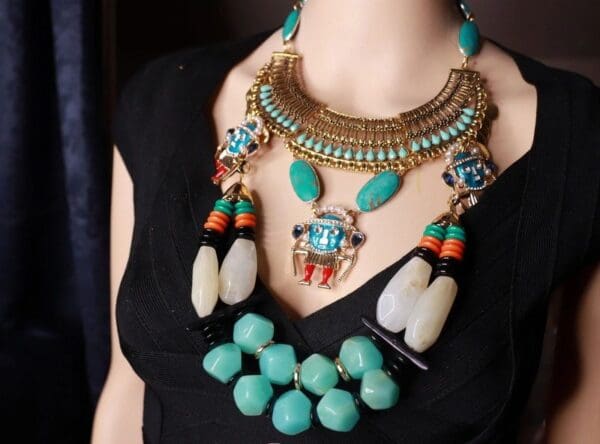 A woman wearing multiple necklaces and bracelets.